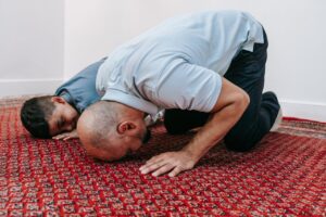 Father and son praying in mosque