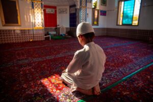 Boy praying in mosque